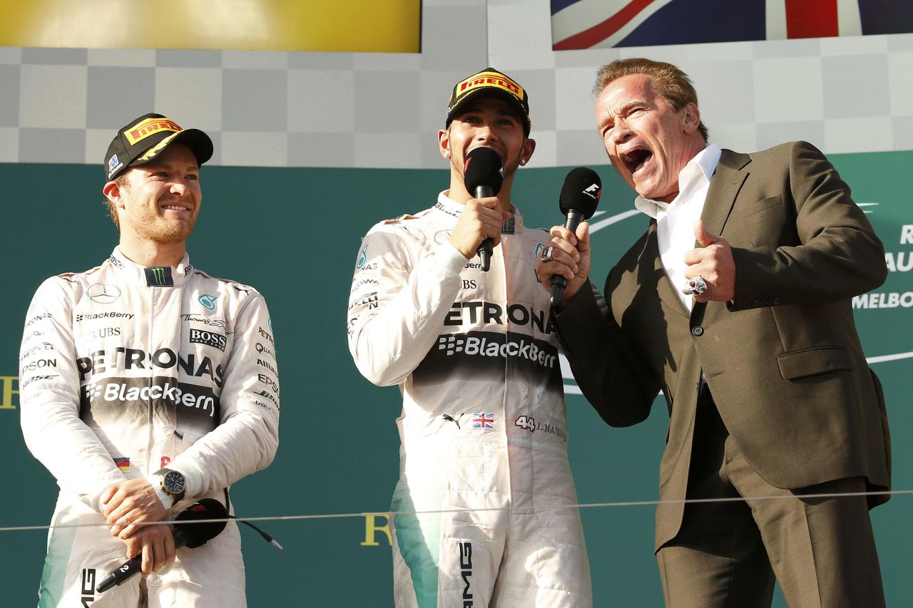 Race winner Mercedes Formula One driver Lewis Hamilton of Britain (C) and actor Arnold Schwarzenegger speak during the podium ceremony of the Australian F1 Grand Prix at the Albert Park circuit in Melbourne March 15, 2015. At left is second placed Mercede