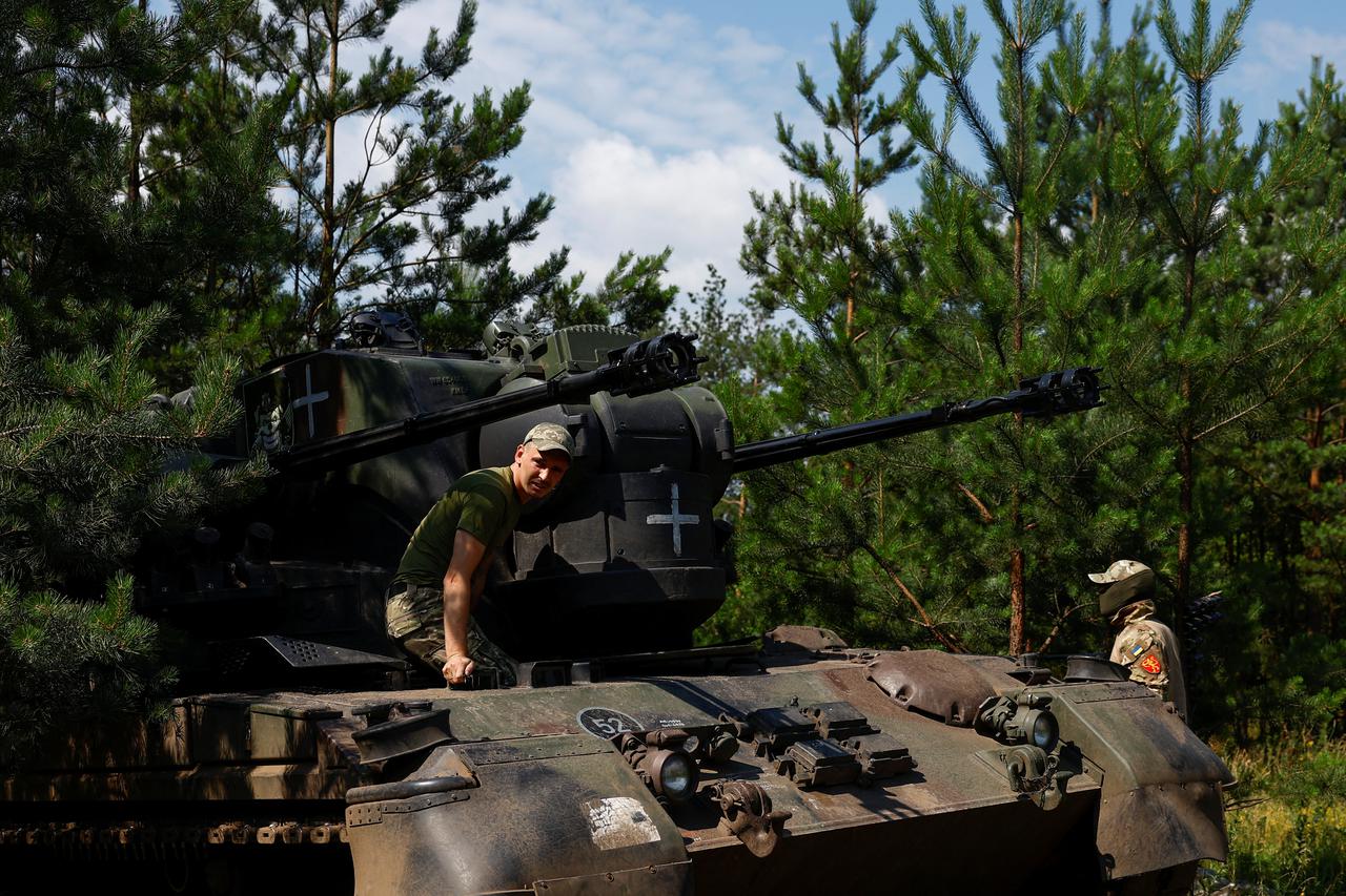 Ukrainian servicemen prepare a Gepard self-propelled anti-aircraft gun for work during their combat shift in Kyiv region