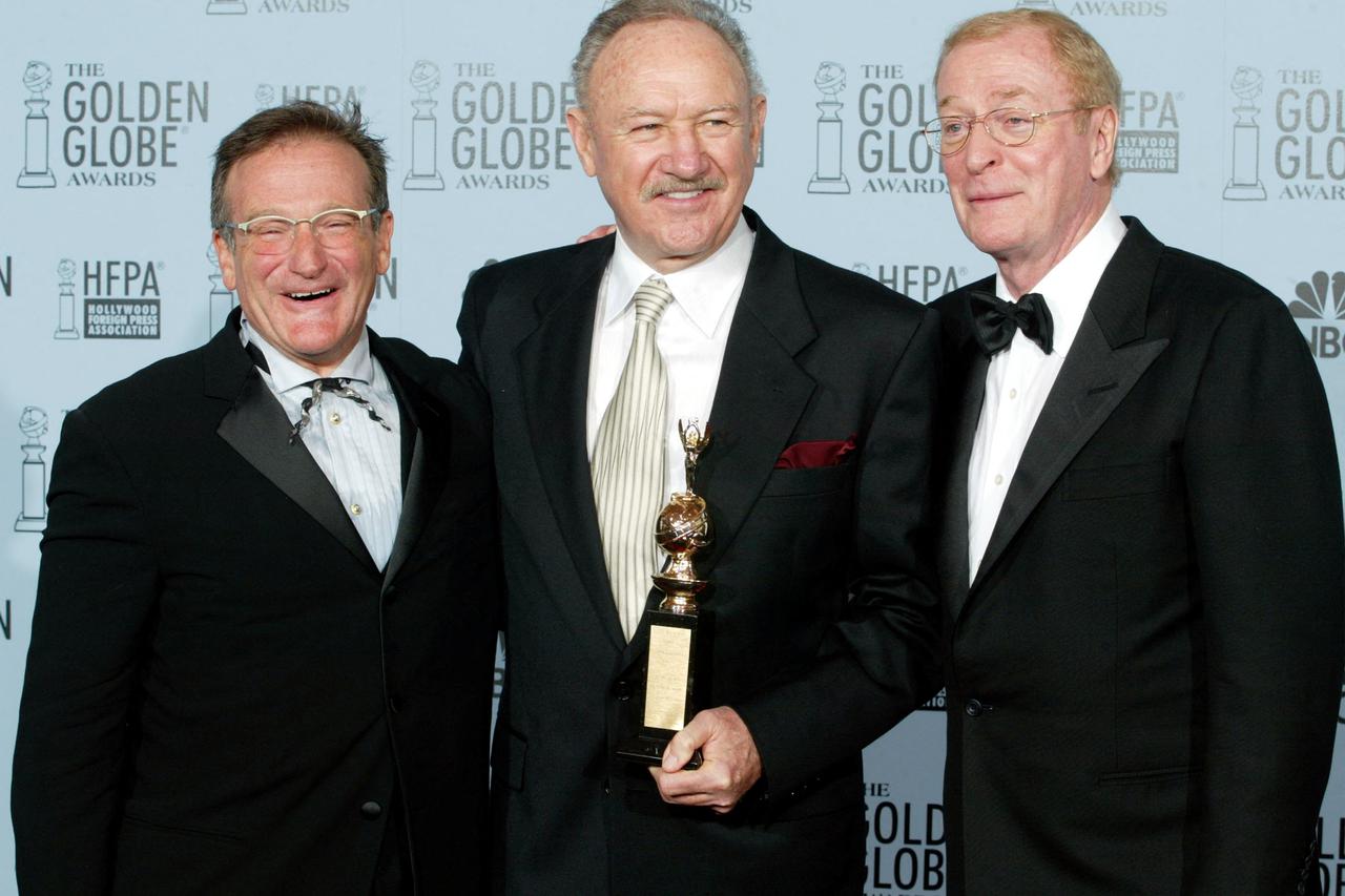 FILE PHOTO: Hackman holds Cecil B DeMille award with Williams and Caine