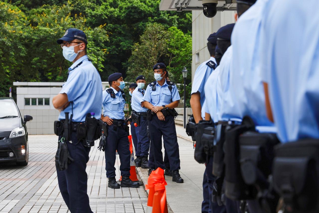 Police stand guard outside the High Court during court hearing of Tong Ying-kit, the first person charged under a new national security law, in Hong Kong