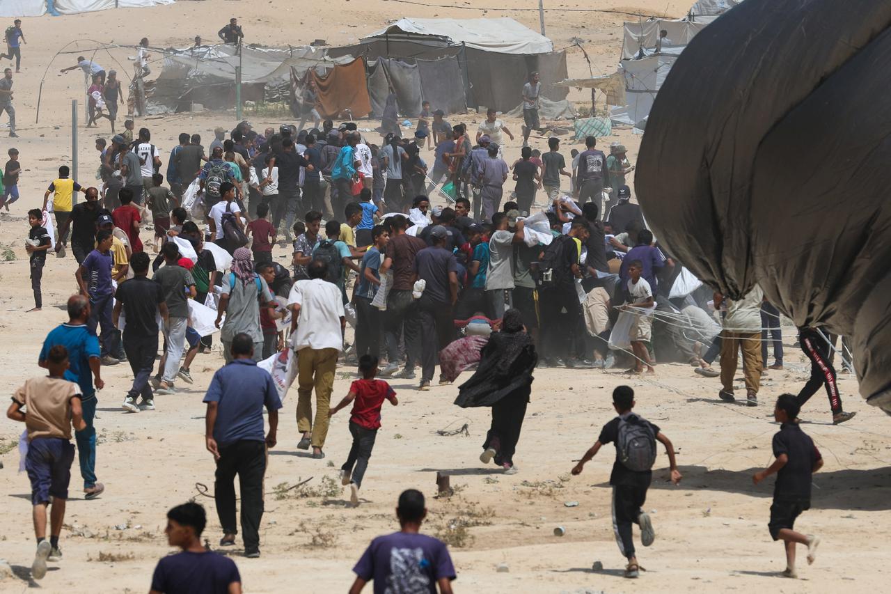 Aid packages are airdropped over Gaza, in Deir Al-Balah