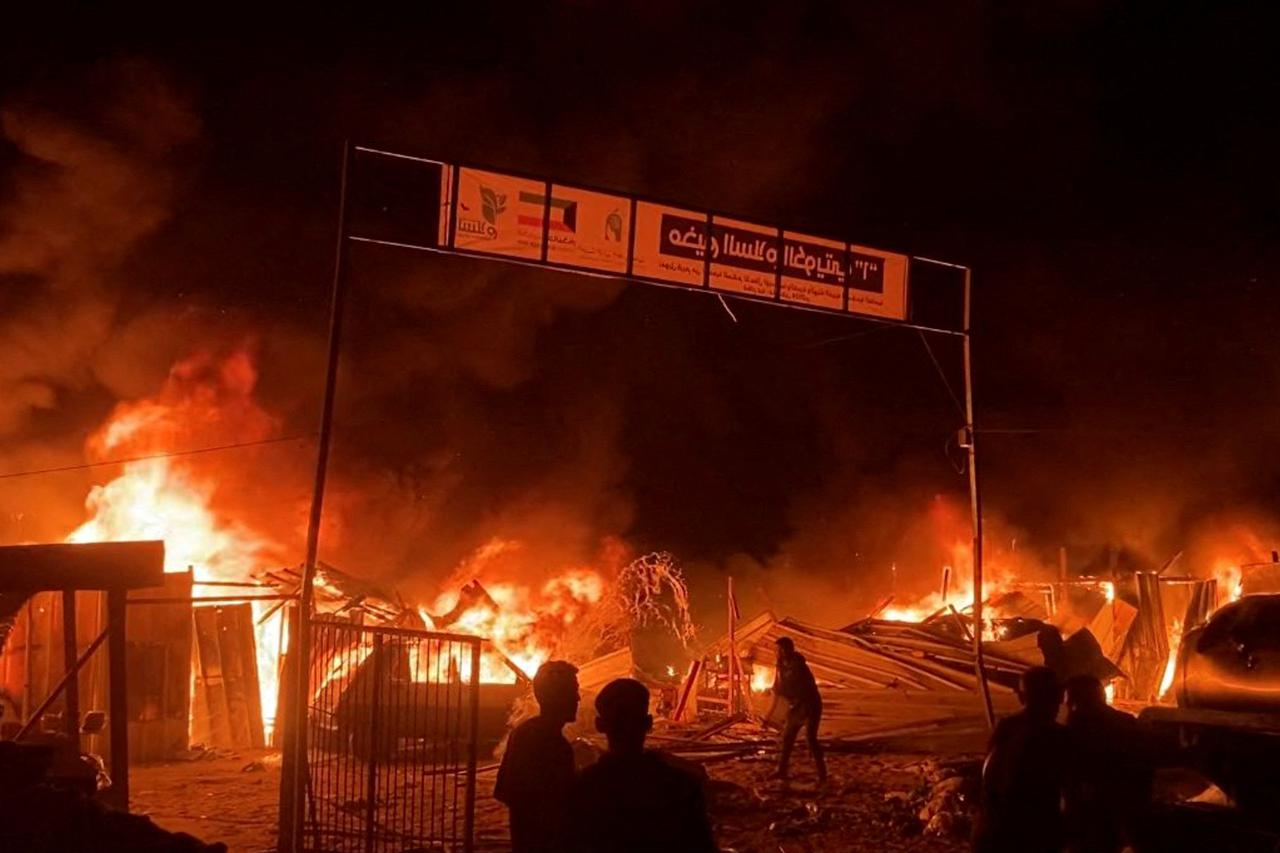 Fire rages following an Israeli strike on an area designated for displaced Palestinians, in Rafah