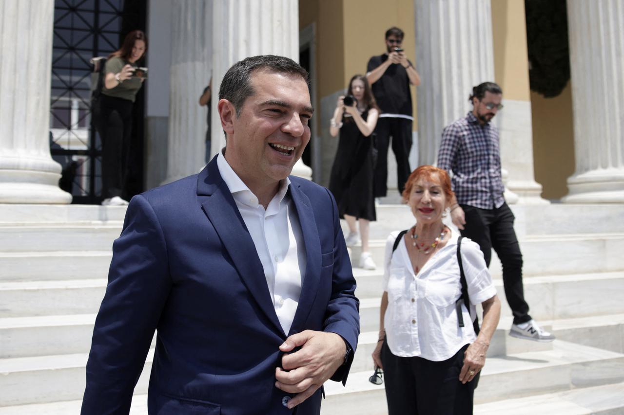 Leftist Syriza party leader Alexis Tsipras leaves after making a statement at the Zappeion Hall in Athens