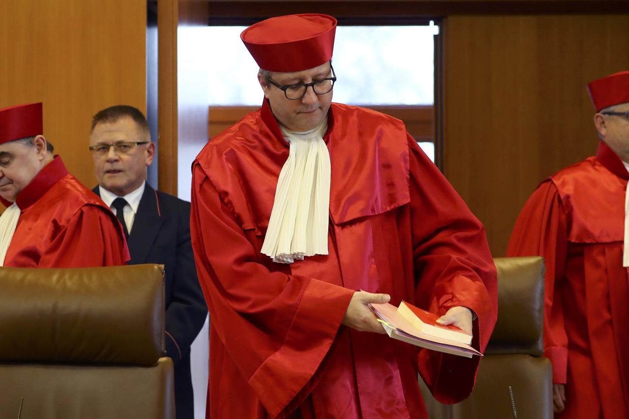 Judges of the second senate of the German Constitutional Court, Peter Mueller (l-r), cheif judge Andreas Vosskuhle and Peter M. Huber, arrive for the announcement of the verdict on the NPD ban proceedings at the German constitutional court in Karlsruhe, G