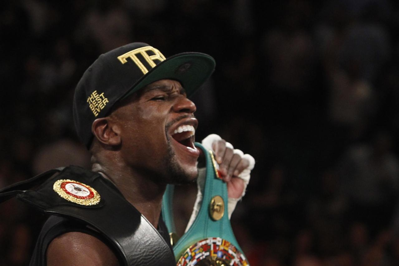 'Floyd Mayweather Jr. of the U.S. celebrates his victory over WBC/WBA 154-pound champion Canelo Alvarez at the MGM Grand Garden Arena in Las Vegas, Nevada, September 14, 2013. Alvarez was previously u