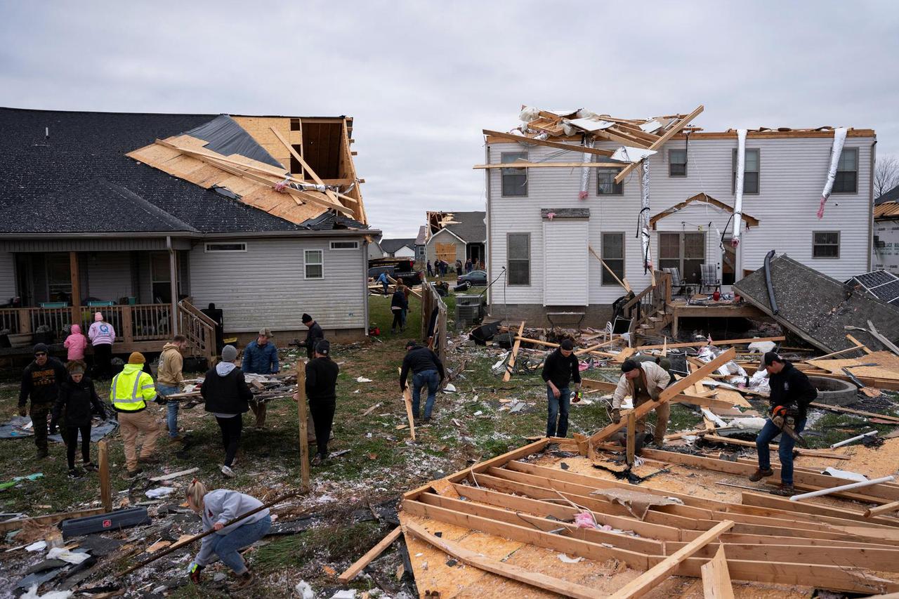 Debris spills from a damaged home after a tornado stuck Clarksville