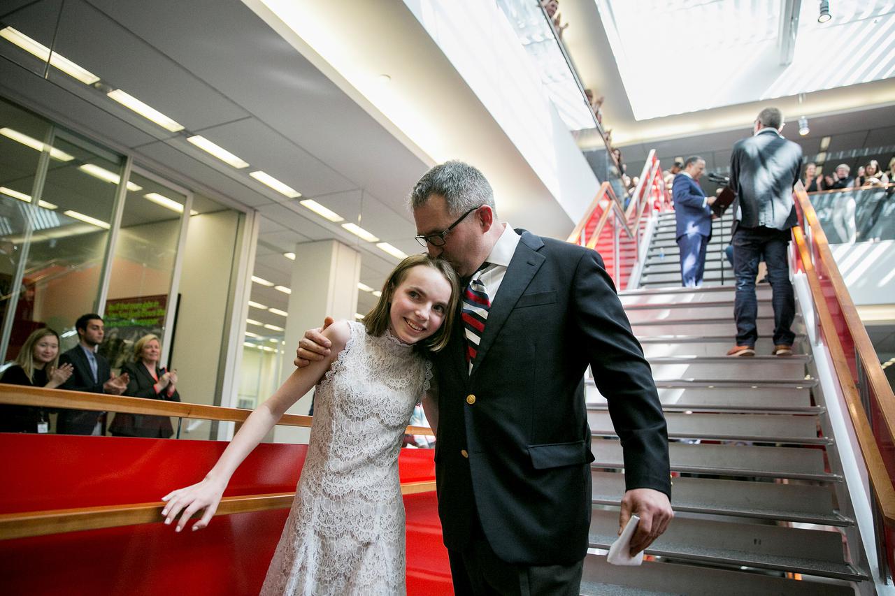 C.J. Chivers embraces his daughter, Elizabeth, 13, during a gathering of the newsroom at The New York Times for the announcement of the 2017 Pulitzer Prizes, in New York, U.S., April 10, 2017. Chivers won for a magazine piece on a young veteran of the war