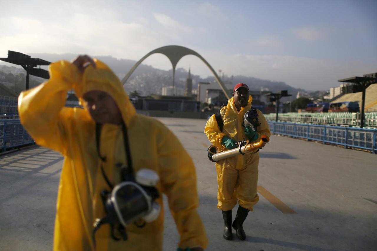 Municipal workers walk after spraying insecticide at Sambodrome in Rio de Janeiro, Brazil, January 26, 2016. Municipal workers sprayed insecticide around Sambadrome, where the city's Carnival takes place every year, and where the archery competitions will