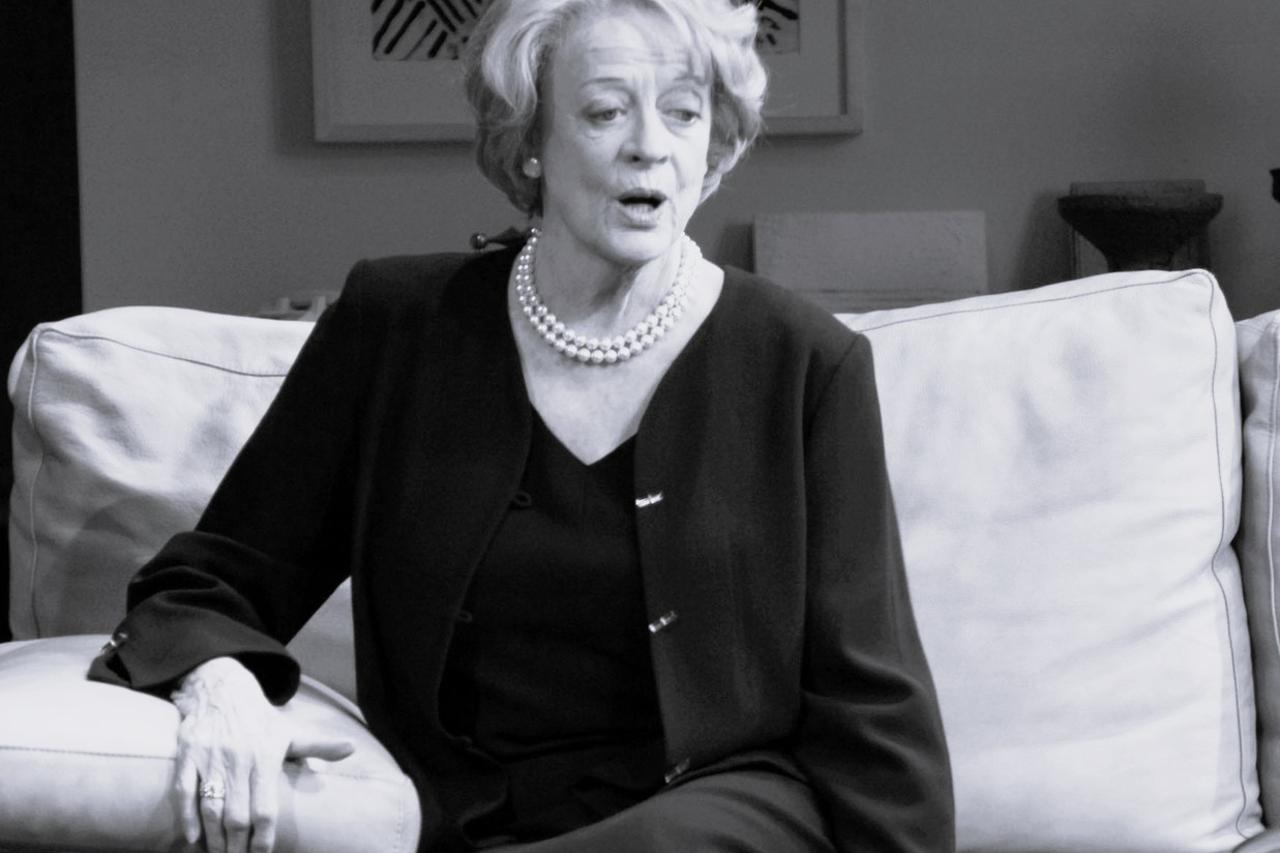 FILE PHOTO: Downton Abbey cast member Maggie Smith poses for the media at a hotel in London