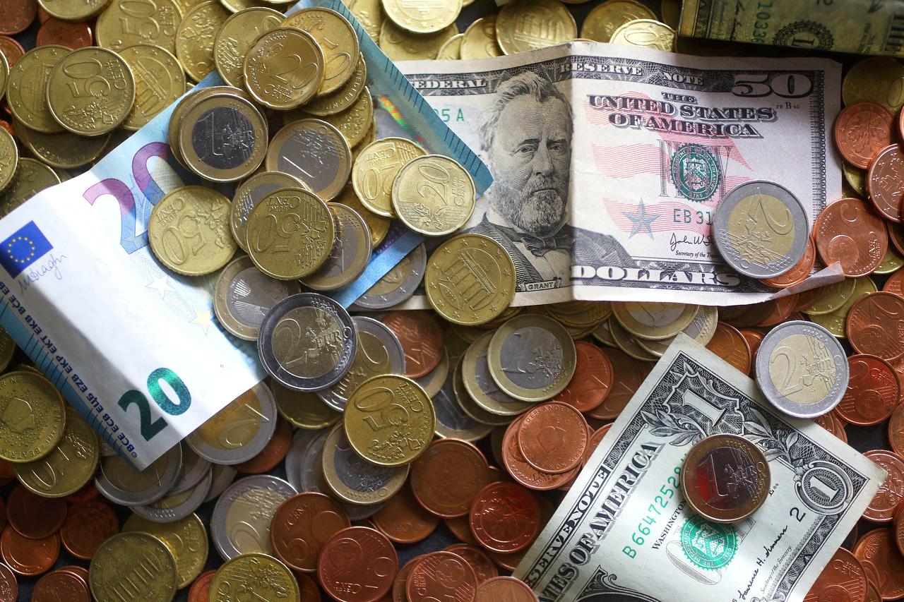 FILE PHOTO: An illustration picture shows euro and US dollar banknotes and coins