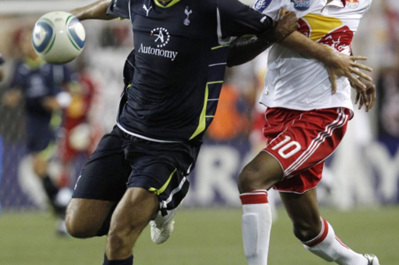 'Verdan Corluka of Tottenham Hotspur (L) controls the ball away from Macoumba Kandji of Major League Soccer\'s New York Red Bulls during the second half of their game at Red Bull Arena in Harrison, Ne
