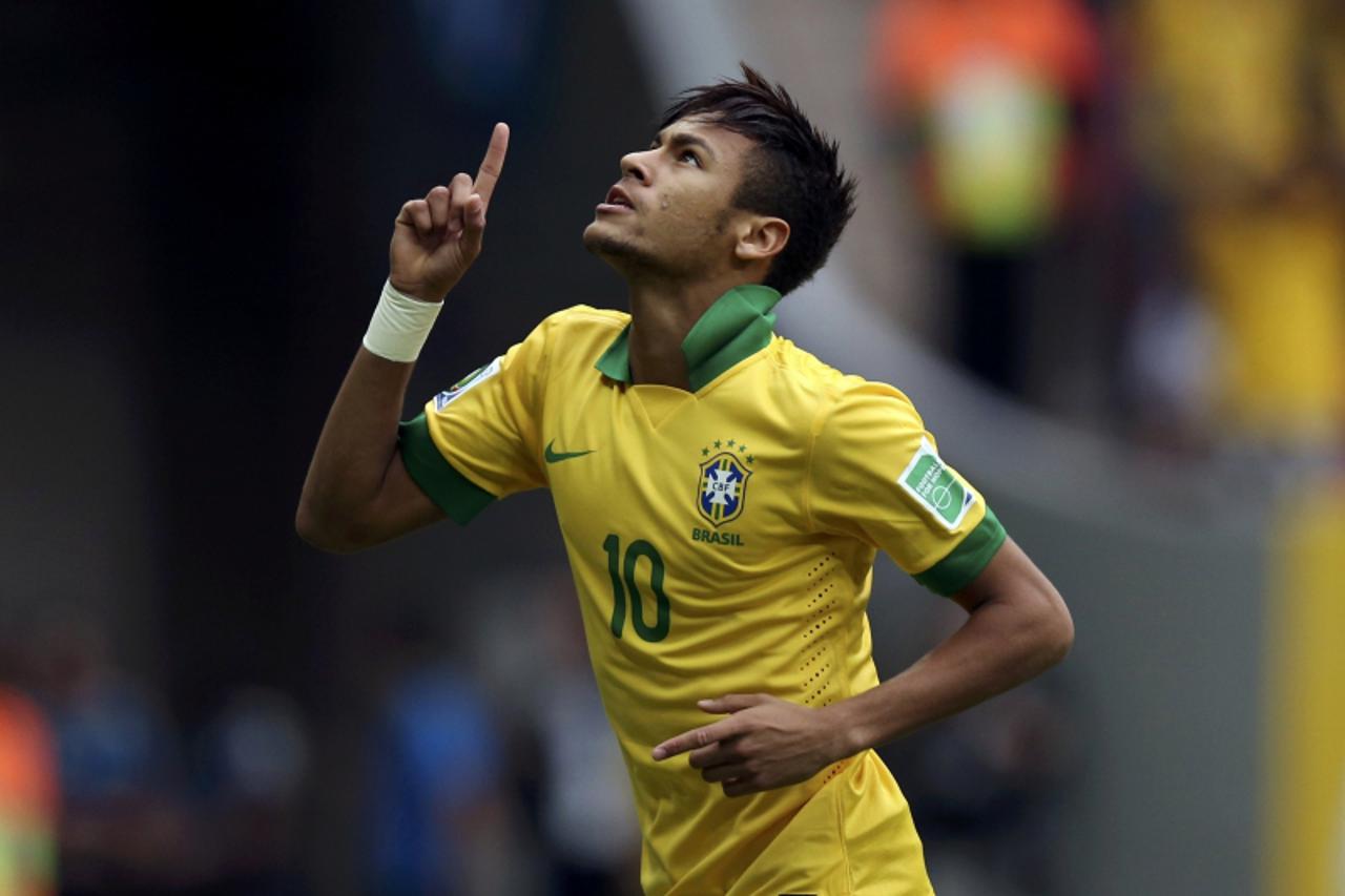 'Brazil\'s Neymar celebrates after scoring a goal during their Confederations Cup Group A soccer match against Japan at Estadio Nacional in Brasilia June 15, 2013.  REUTERS/Ueslei Marcelino (BRAZIL  -