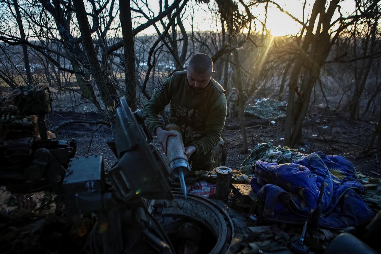 A Ukrainian serviceman uploads shells in a tank in Luhansk region