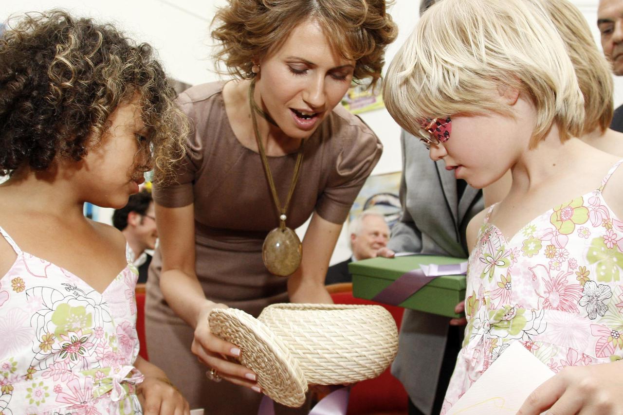 A handout released by SOS Children?s Village pictures Syrian First Lady Asma Al Assad (C) meeting with children, mothers and staff of the SOS Children's Village in Hinterbuehl, near Vienna, Austria, 27 April 2009. Hinterbuehl is the largest SOS Children's