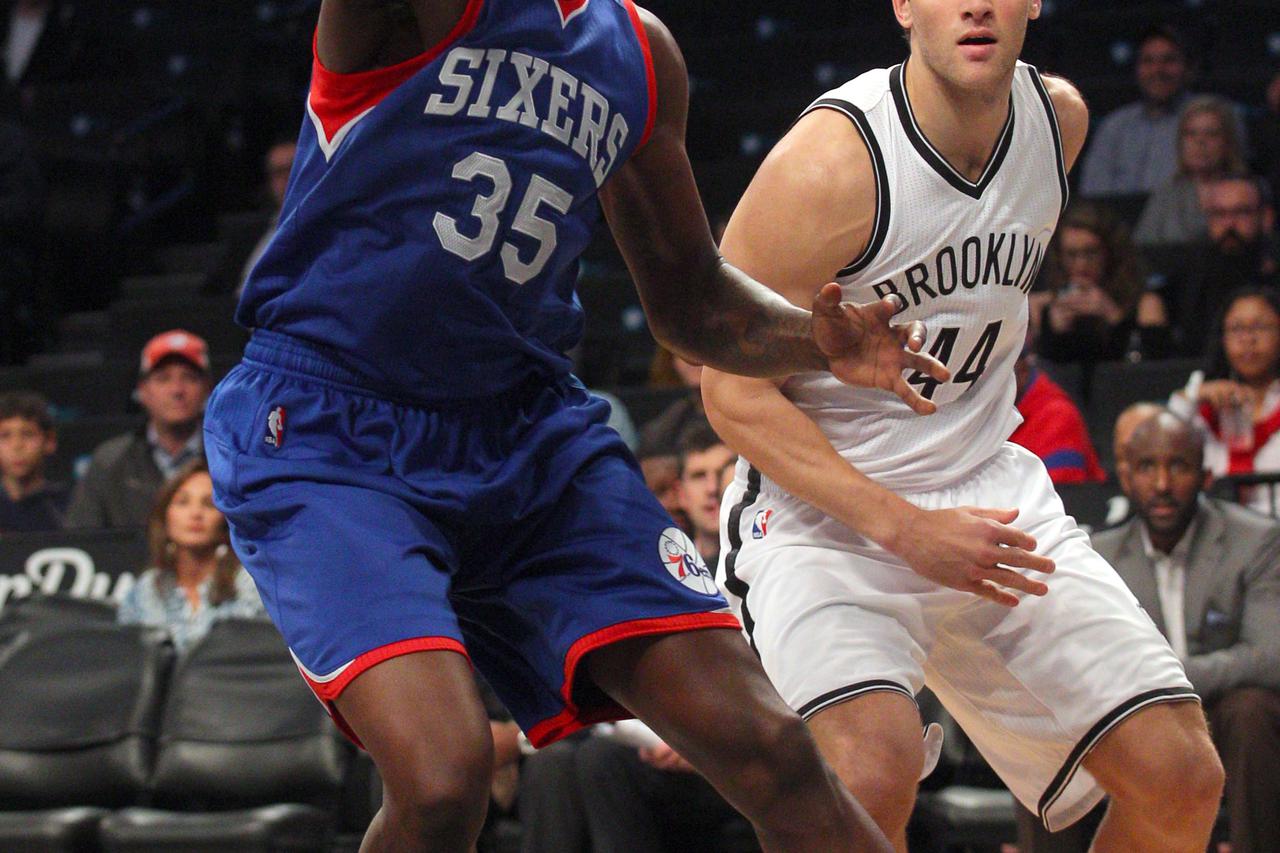 Oct 20, 2014; Brooklyn, NY, USA; Philadelphia 76ers center Henry Sims (35) grabs a rebound in front of Brooklyn Nets small forward Bojan Bogdanovic (44) during the first quarter at Barclays Center. Mandatory Credit: Brad Penner-USA TODAY Sports
