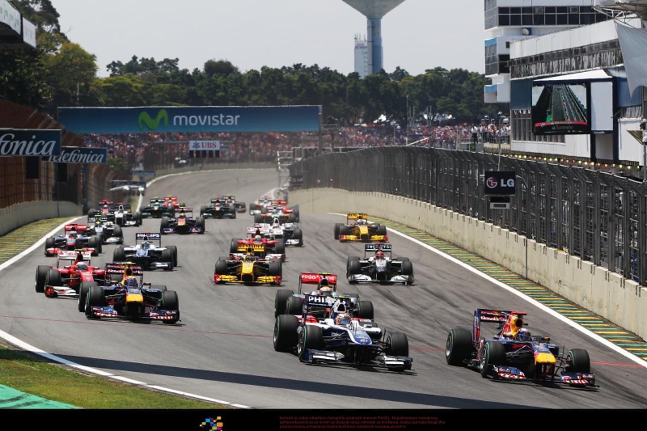 'Sebastian Vettel (GER) Red Bull Racing RB6 passes Nico Hulkenberg (GER) Williams FW32 at the start of the race.  Photo: Press Association/Pixsell'