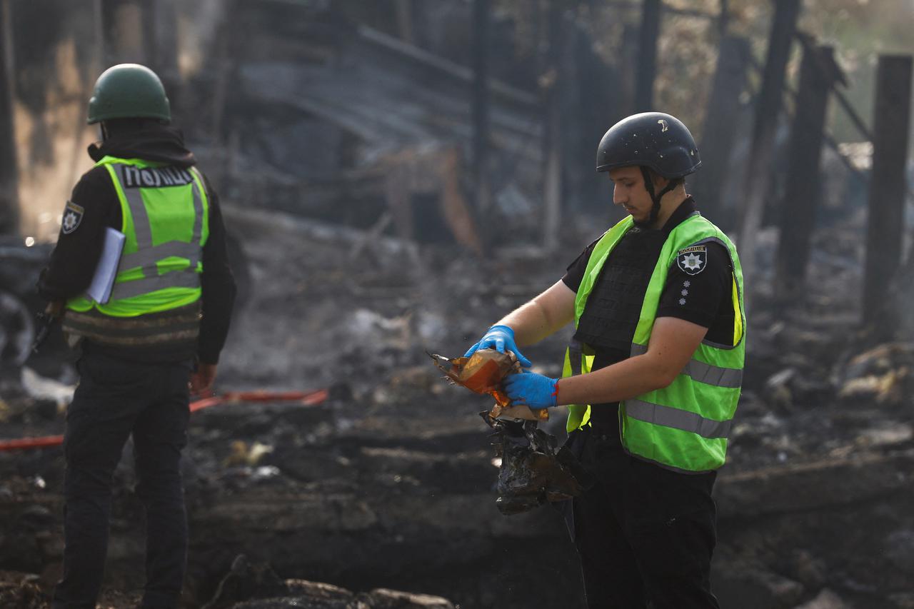 Firefighters work at a site damaged during a Russian missile strike, in Kyiv