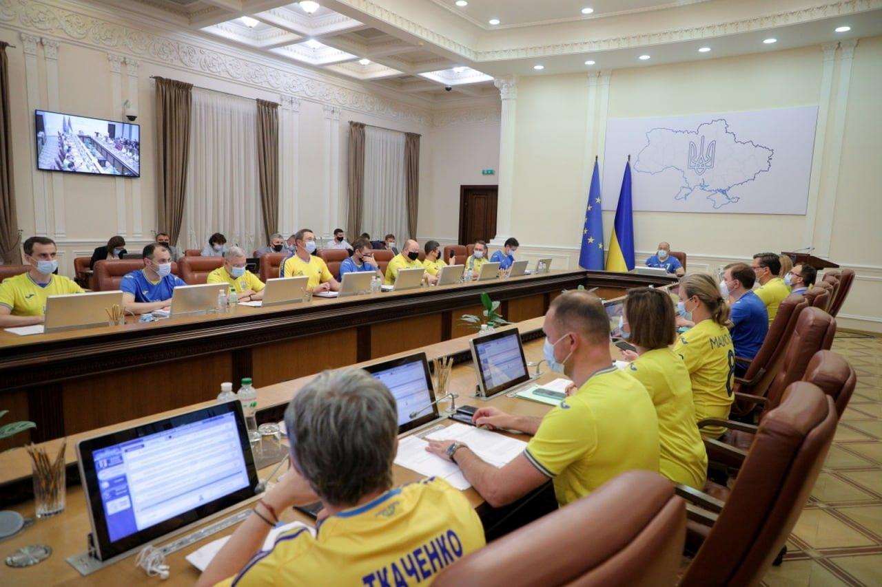 Ukrainian ministers wear the soccer national team's jerseys during a meeting of the government in Kyiv