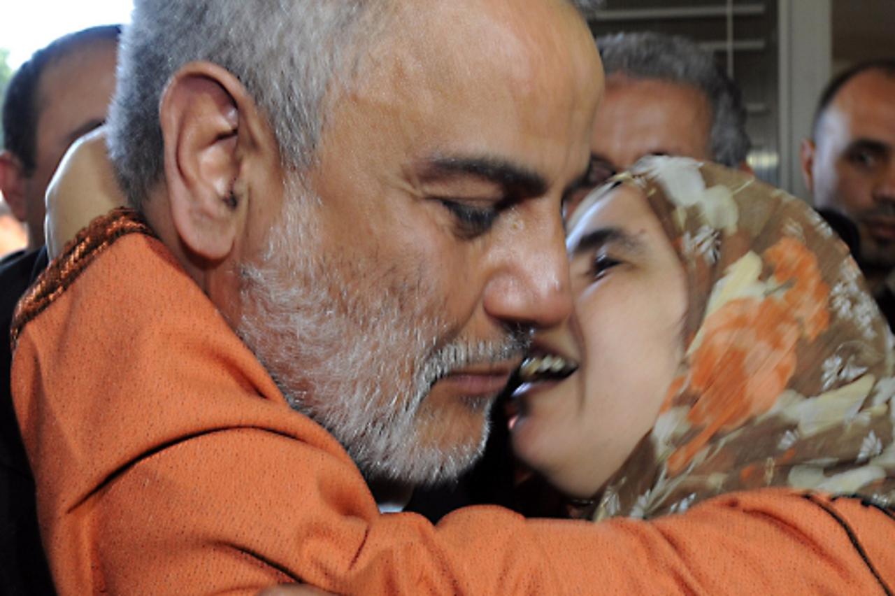 'Abdelilah Benkirane, general secretary of the Justice and Development Party (PJD) party hugs a woman at the party\'s headquarters in Rabat, on November 26, 2011. Morocco\'s moderate Islamists said Sa