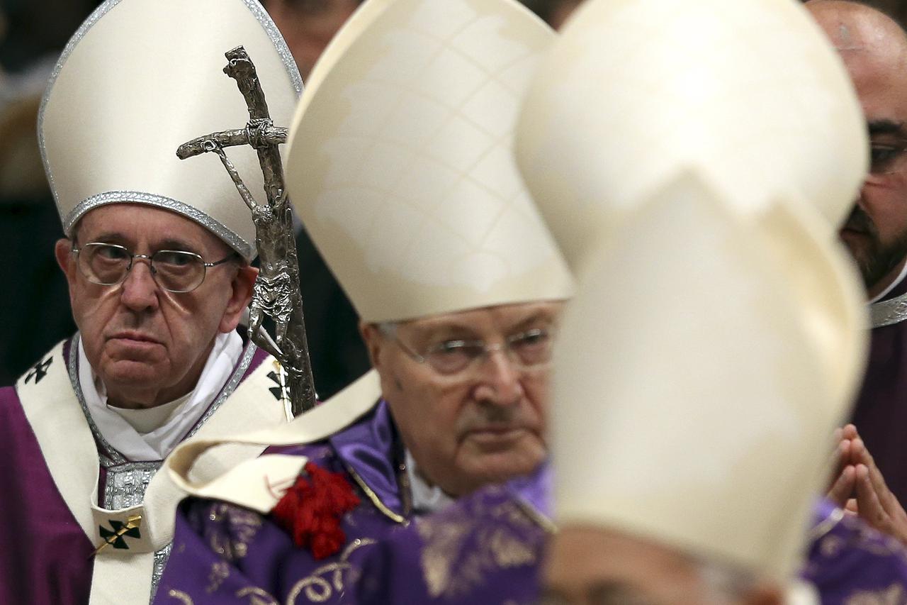 Pope Francis (L) leaves at the end of the Ash Wednesday mass, in St. Peter's Basilica at the Vatican, February 10, 2016. REUTERS/Alessandro Bianchi 
