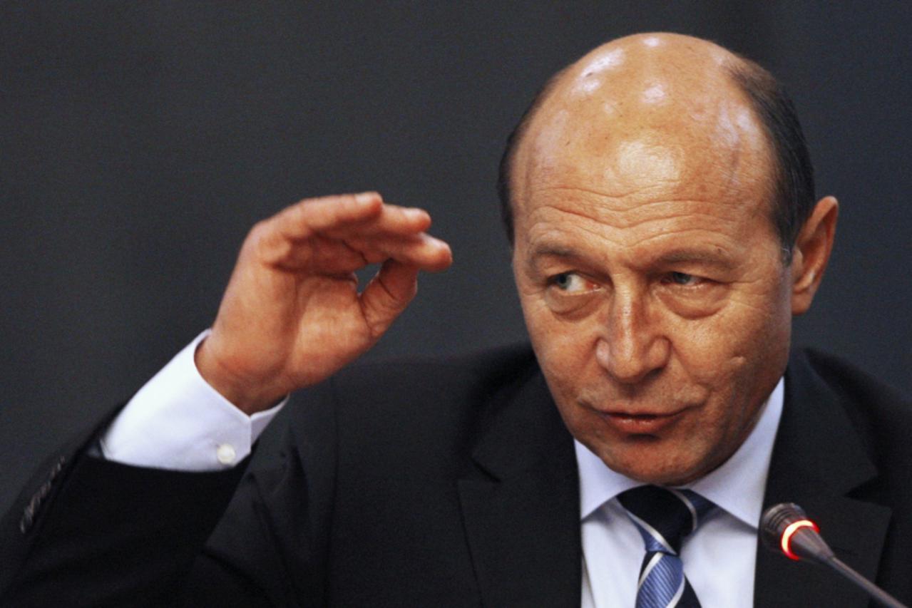 'Romania's incumbent President Traian Basescu gestures during a debate about liberal policies with his supporting party in Bucharest November 24, 2009. After an inconclusive first round on Sunday, bo