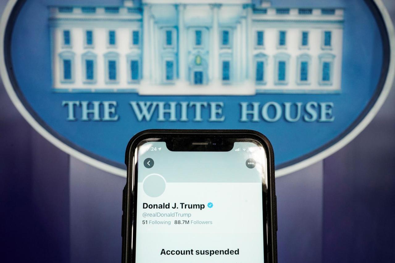 A photo illustration shows the suspended Twitter account of U.S. President Donald Trump on a smartphone at the White House briefing room in Washington