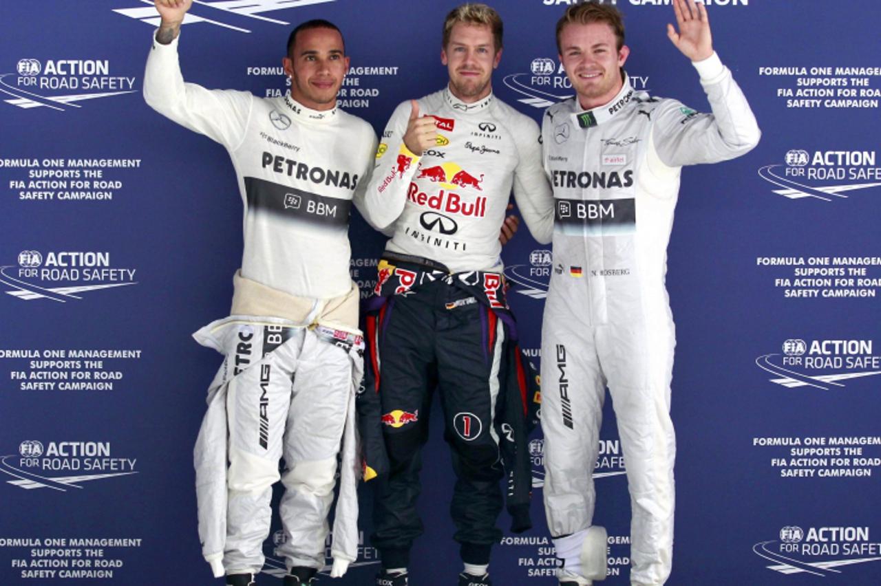'(L-R) Mercedes Formula One driver Lewis Hamilton of Britain, Red Bull Formula One driver Sebastian Vettel of Germany and Mercedes Formula One driver Nico Rosberg of Germany pose for photographers aft