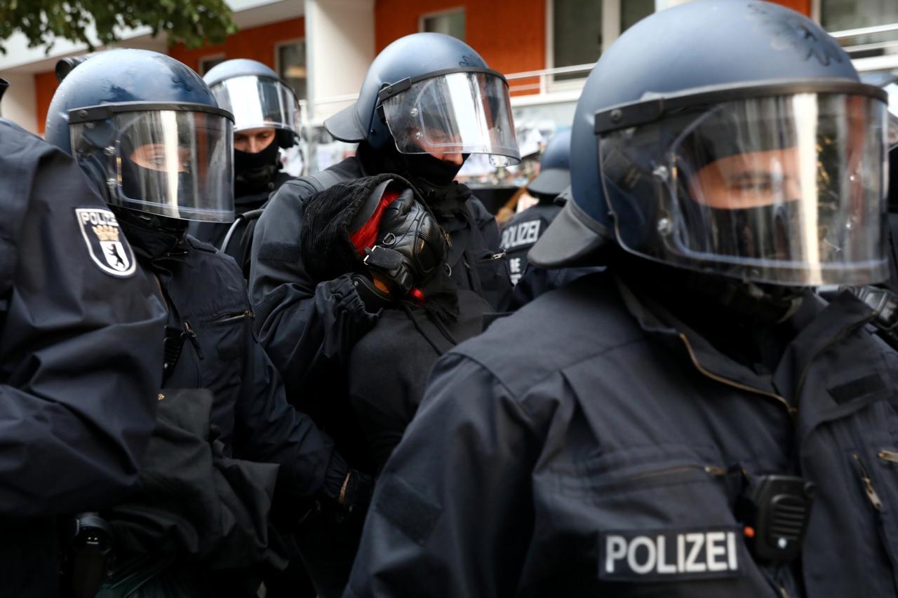 Demonstrators protest by the squatted left-wing housing project Liebigstrasse 34, which faces eviction by the police in Berlin