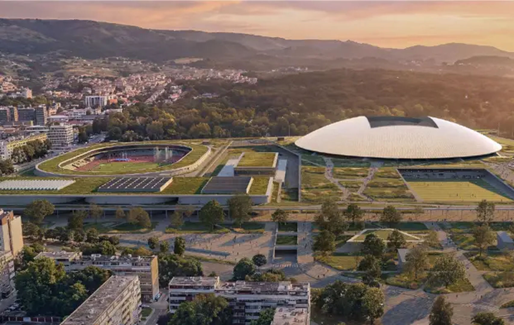Kontinuirana kupolasta ploha, oslonjena u osam točaka, obuhvaća tribinsku zdjelu i oblikuje prepoznatljivu, nisku siluetu stadiona. Glavni pristup vodi preko povišene javne platforme koja se uvlači pod krov i povezuje vanjski prostor s ophodnim prstenom tribina. U anketnom dijelu ista zelena platforma povezuje atletski stadion, sportske dvorane i otvorene sadržaje, dok su promet i parkiranje spušteni pod teren prema Borongaju.
