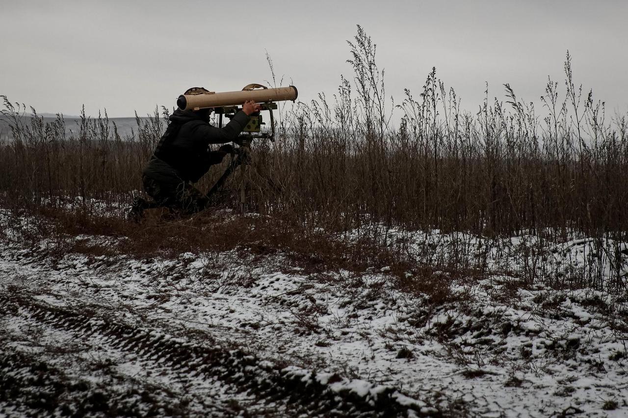 A Ukrainian service member prepares an anti-tank guided missile weapon system on a frontline near the town of Soledar
