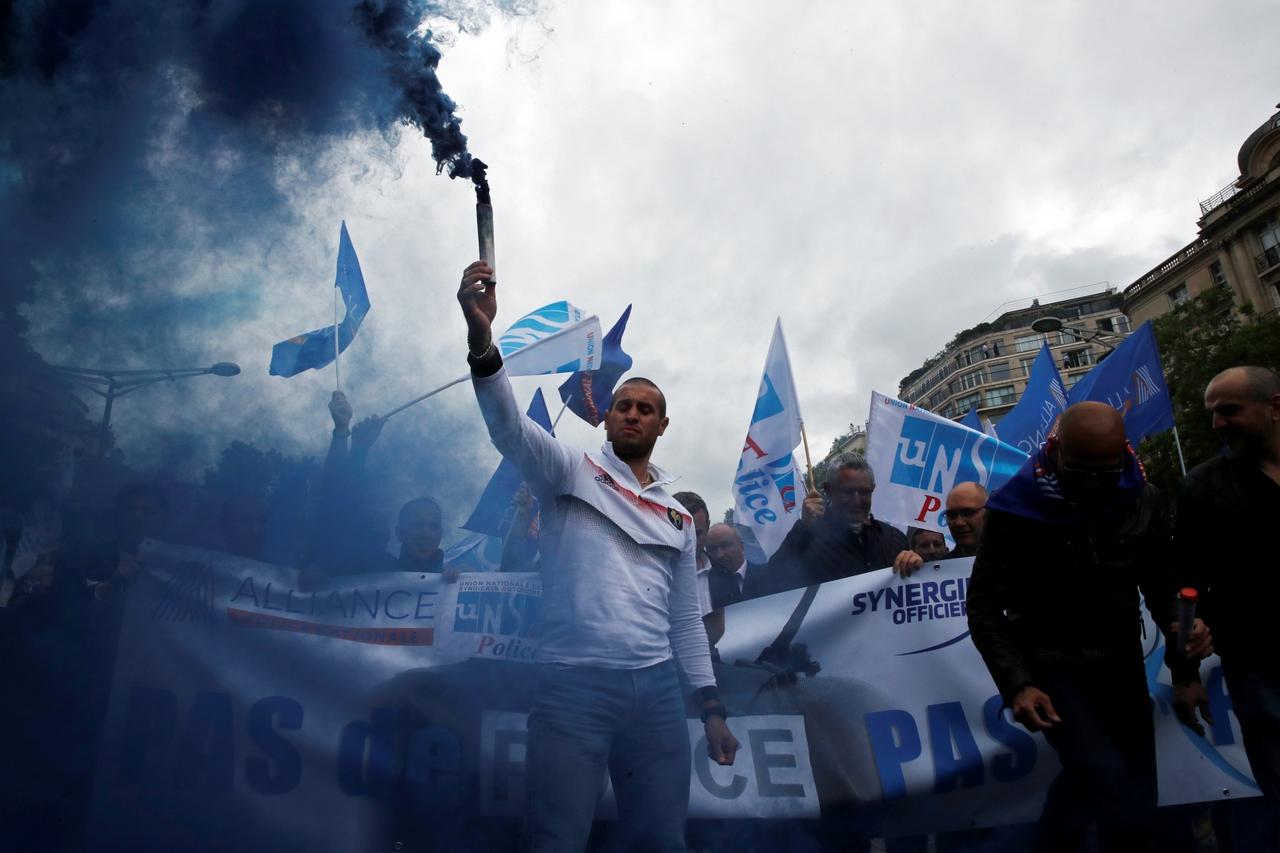 Police officers attend a demonstration in Paris