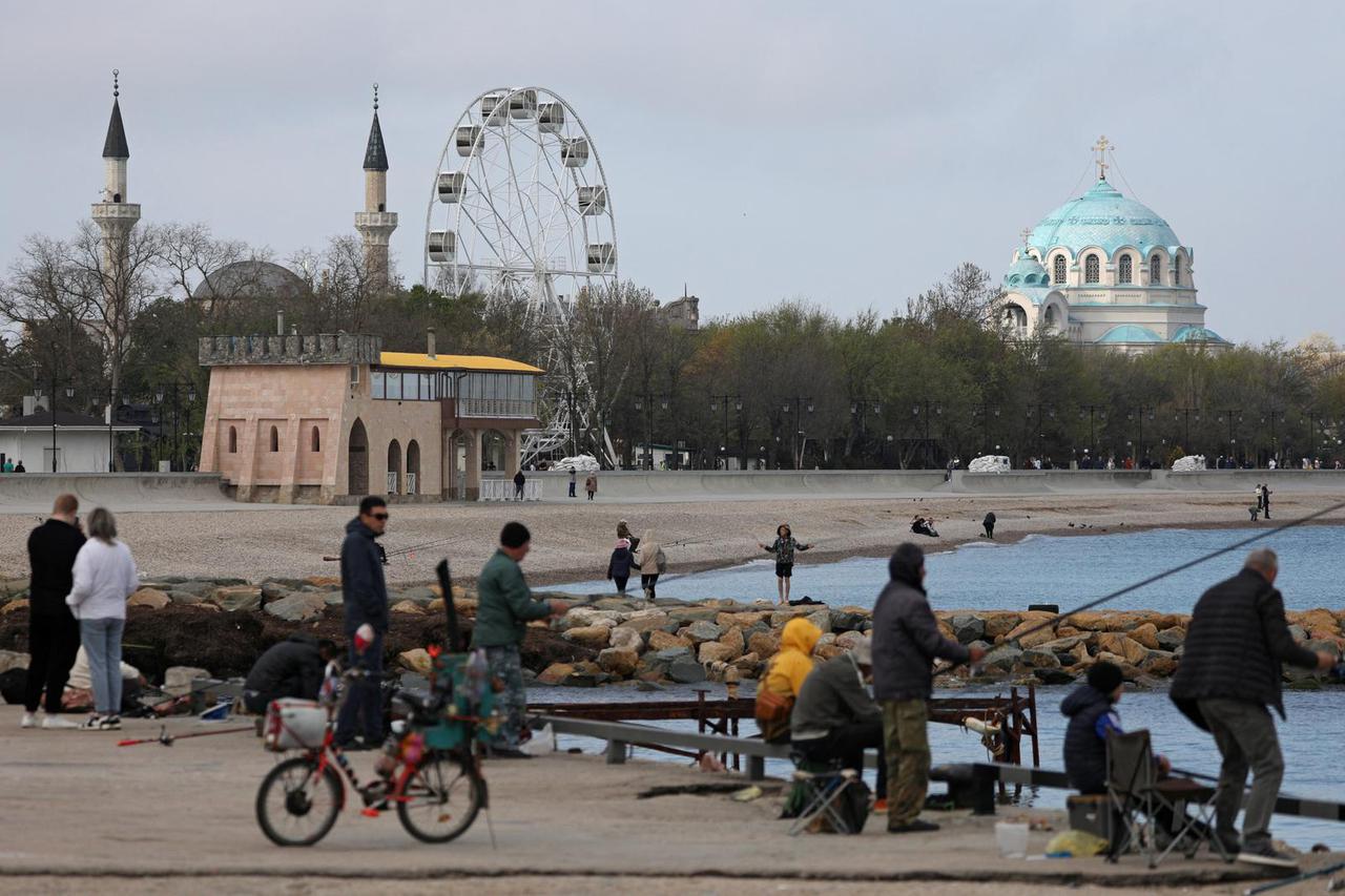 People fish on an embankment in Yevpatoriya