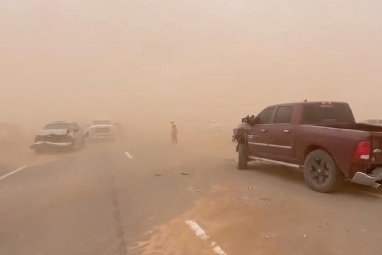 A still image shows vehicles stranded on a road in New Mexico as a dust storm sweeps through