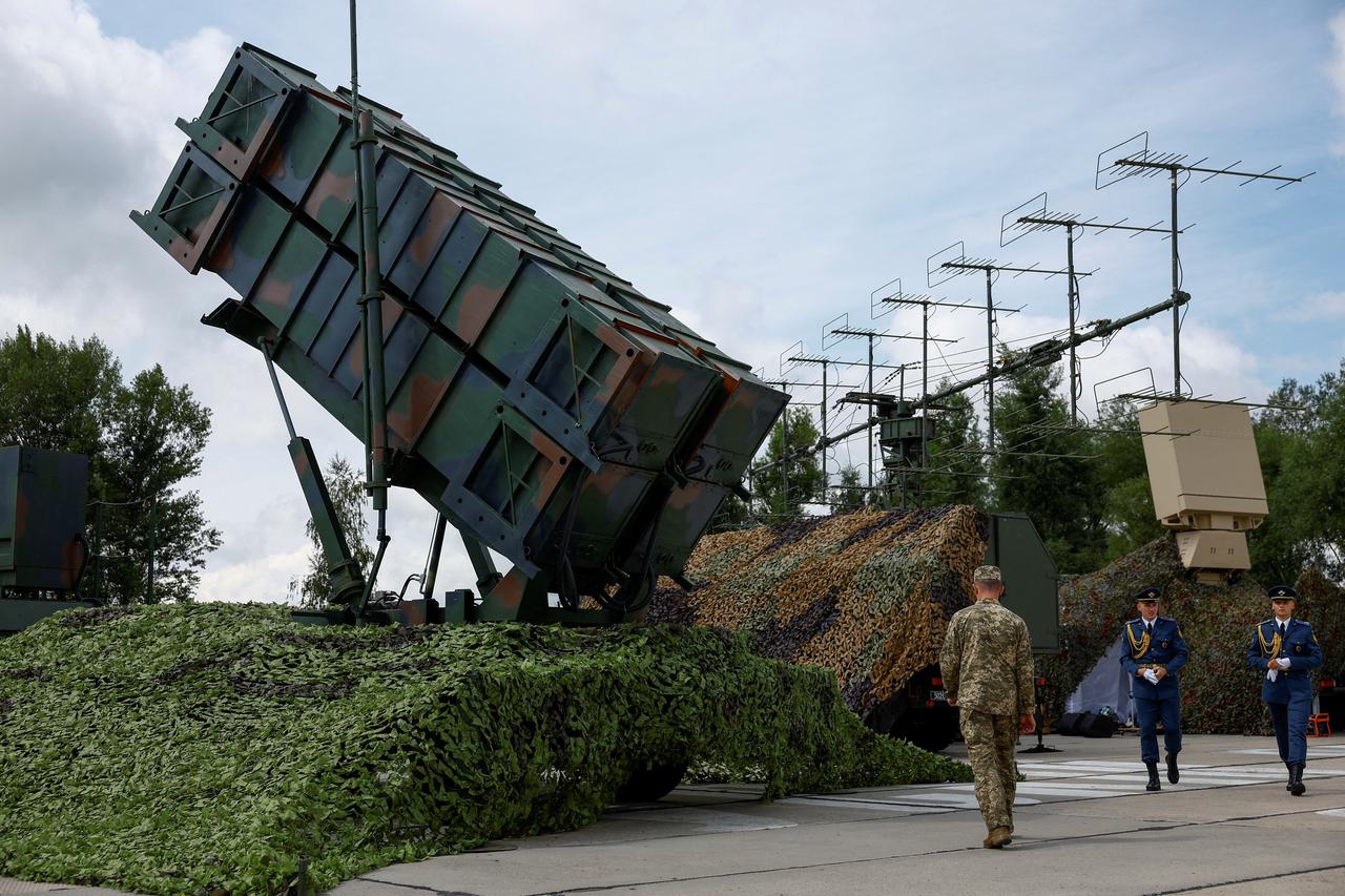 FILE PHOTO: Ukrainian service members walk next to a launcher of a Patriot air defence system an undisclosed location in Ukraine