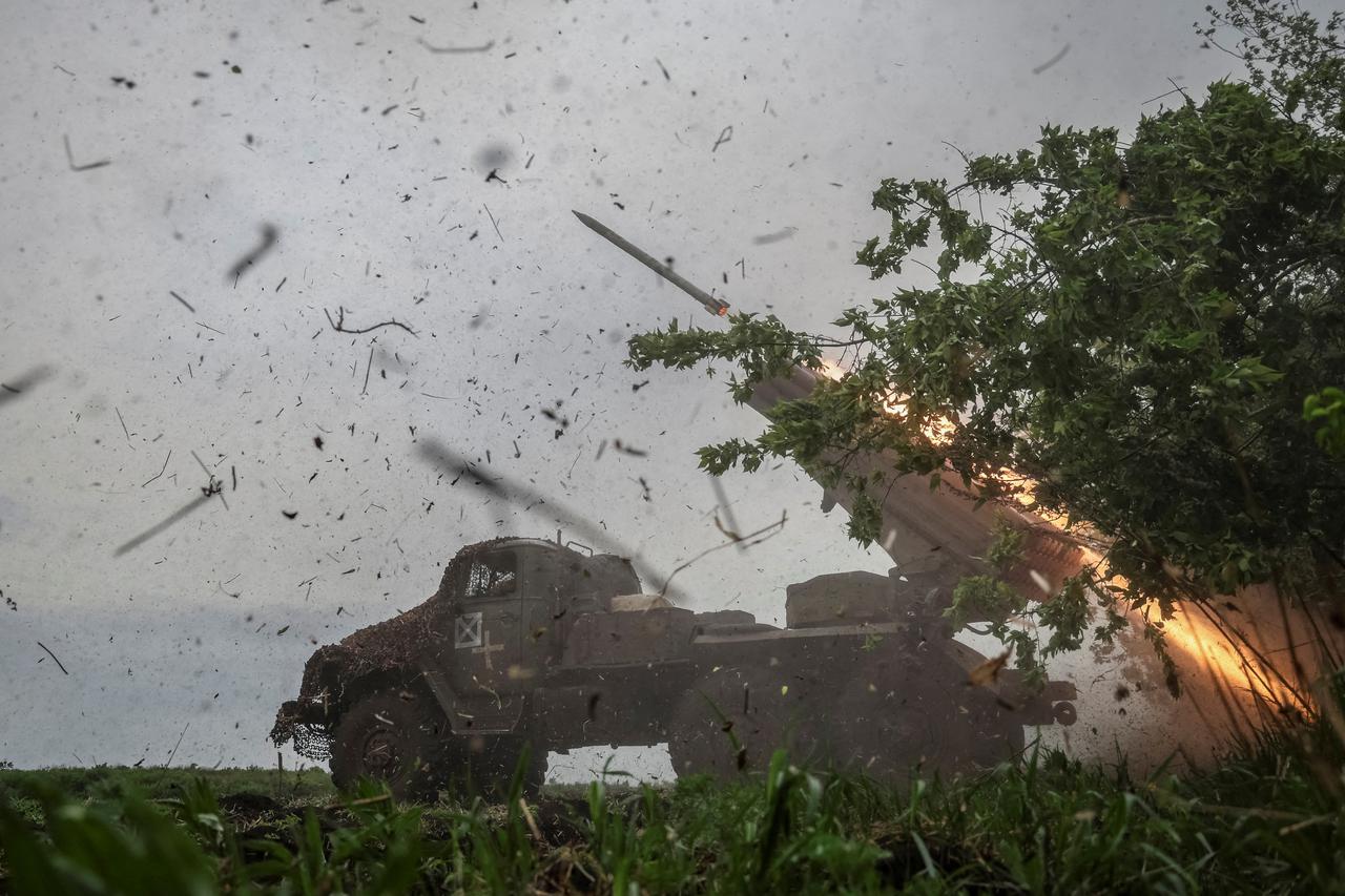 FILE PHOTO: Ukrainian servicemen fire a BM-21 Grad multiple launch rocket system towards Russian troops in Donetsk region