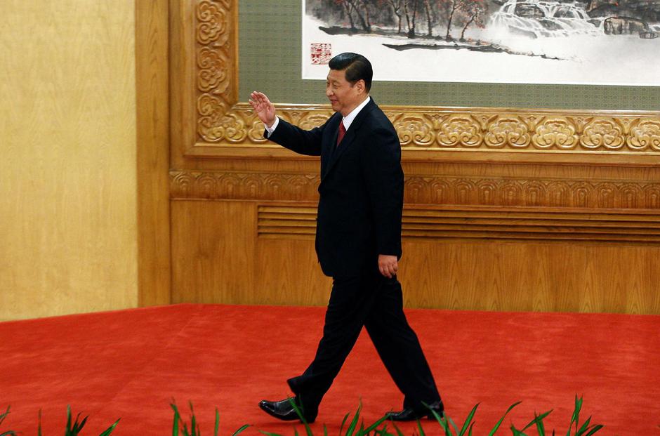 FILE PHOTO: Newly-elected General Secretary of the Central Committee of the Communist Party of China Xi Jinping leaves after meeting with the press in Beijing