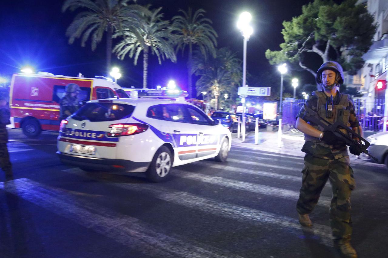 French soldiers and police secure the area after at least 30 people were killed in Nice, France, when a truck ran into a crowd celebrating the Bastille Day national holiday July 14, 2016.  REUTERS/Eric Gaillard