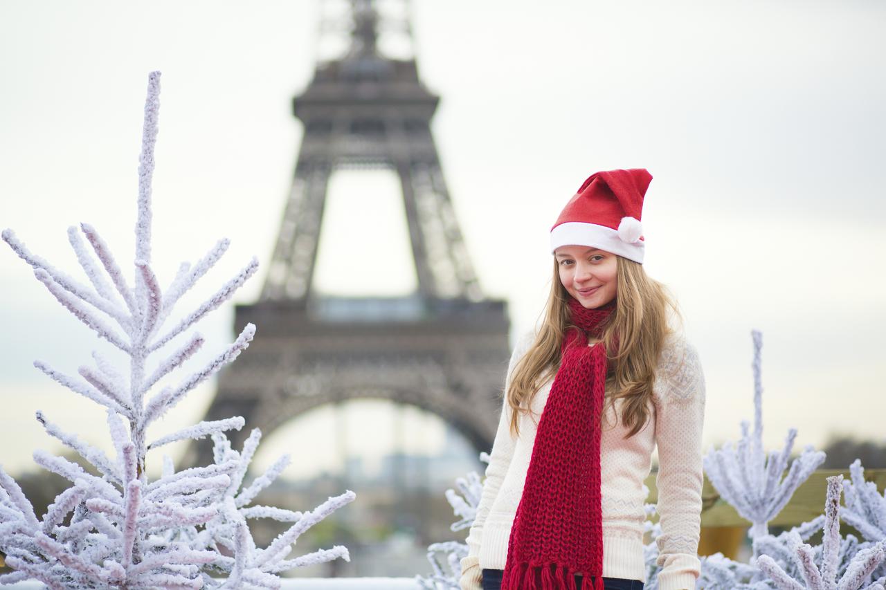 Girl in Santa hat near the Eiffel tower