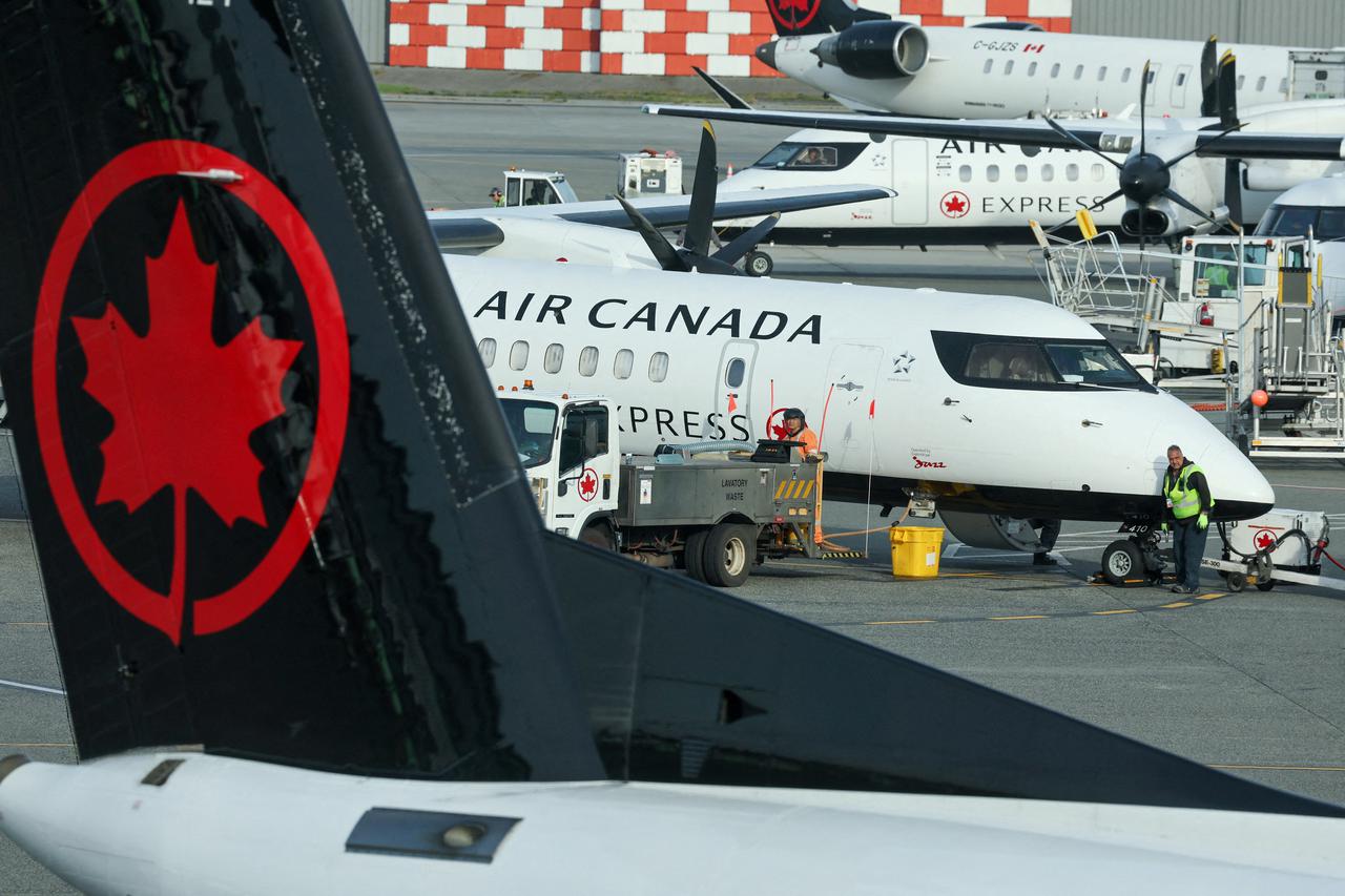 FILE PHOTO: Ground crew service an Air Canada passenger plane at the domestic terminal of Vancouver International Airport in Richmond
