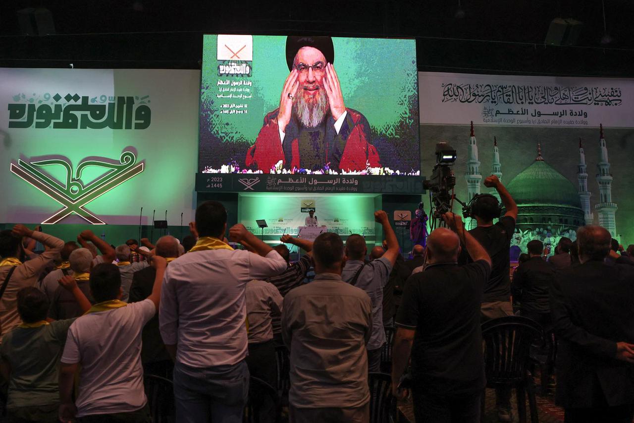 Lebanon's Hezbollah leader Sayyed Hassan Nasrallah addresses his supporters via a screen during a rally marking Prophet Mohammed's birthday, in Beirut suburbs