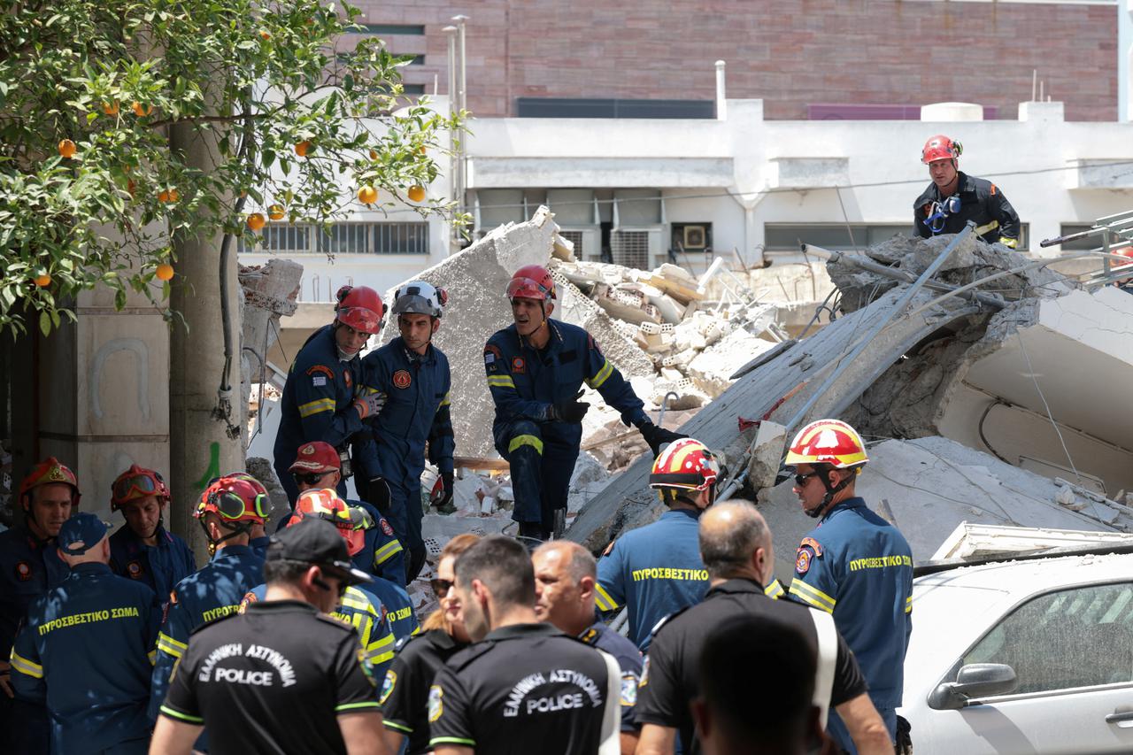 Emergency personnel work at the site of a building collapse in the Petralona neighbourhood of Athens