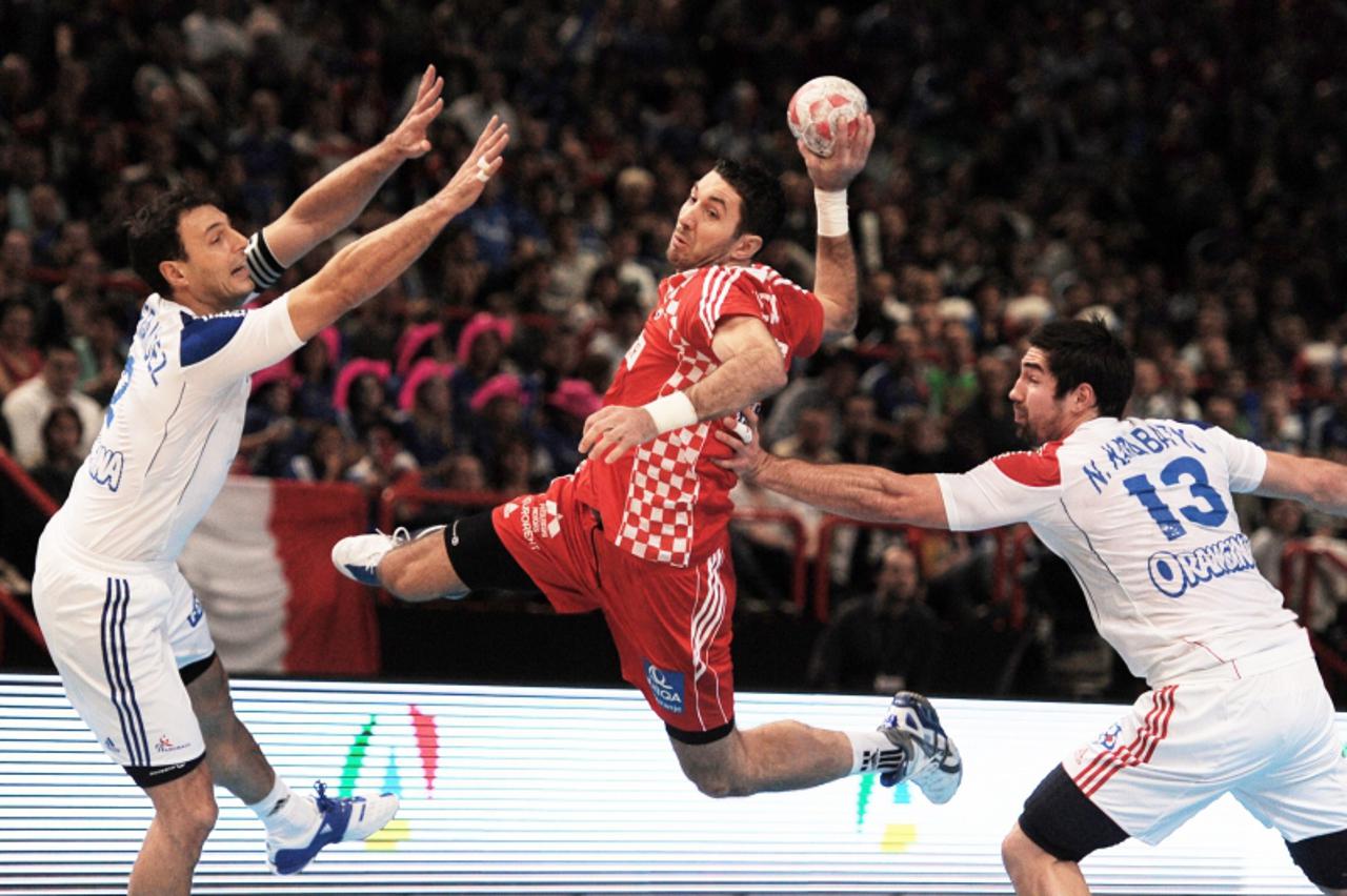 \'Croatia\'s Igor Vori jumps to score during the Paris handball tournament match France vs. Croatia on January 9, 2011 at the Palais-Omnisport de Paris-Bercy (POPB) in Paris. AFP PHOTO / MIGUEL MEDINA