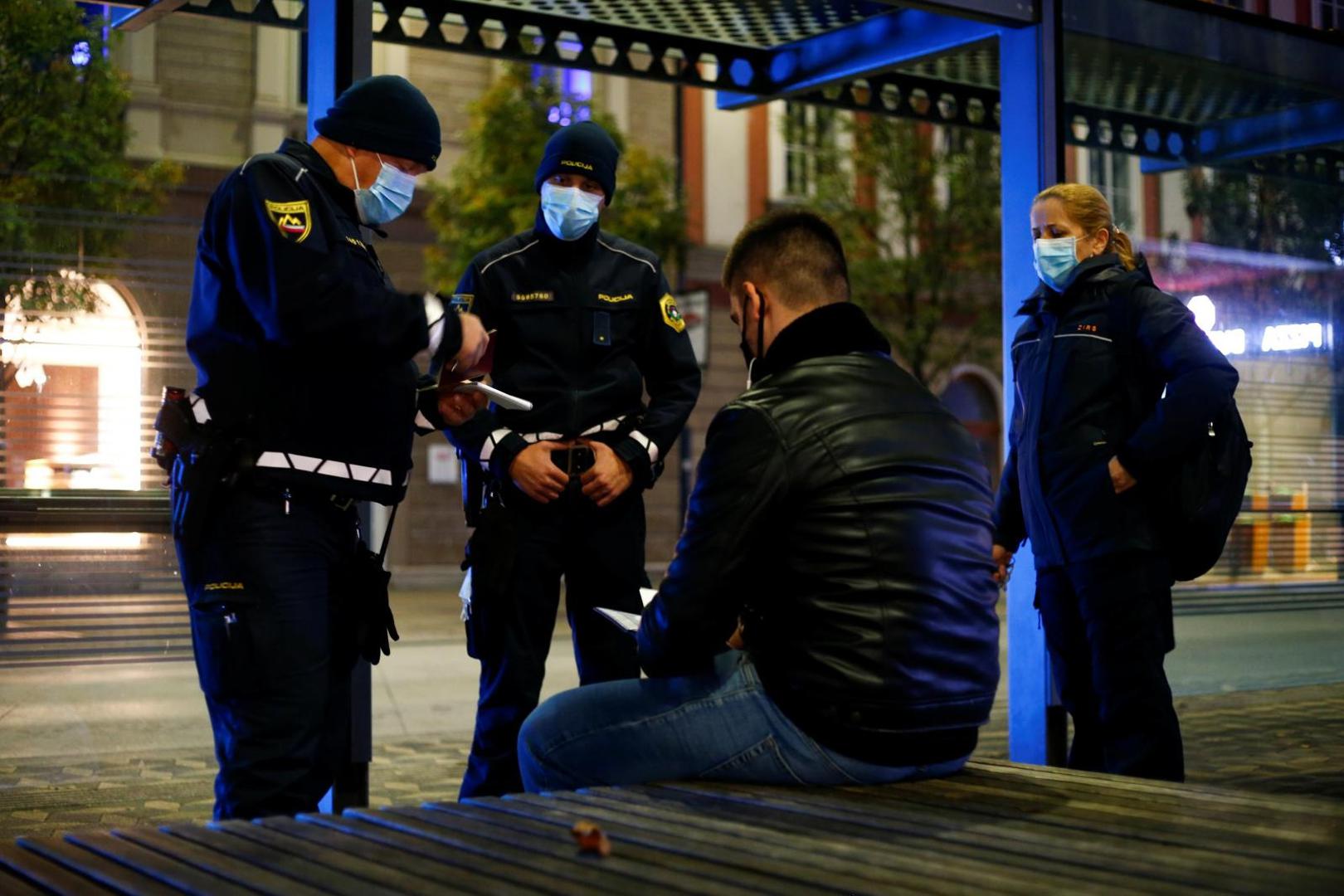 Slovenia starts a nightly curfew from 9 p.m. to 6 a.m as to curb the rising of the coronavirus disease (COVID-19) cases in the country, in Ljubljana Police officers check the documents of a man as Slovenia starts a nightly curfew from 9 p.m. to 6 a.m as part of a state of emergency called to curb the rising of the coronavirus disease (COVID-19) cases in the country, in Ljubljana, Slovenia, October 20, 2020. REUTERS/Borut Zivulovic BORUT ZIVULOVIC