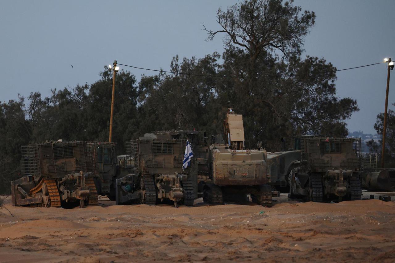 Israeli military armored vehicles sit in a staging area near the Kerem Shalom border crossing, as military operations continue in the southern Gaza city of Rafah, in Kerem Shalom