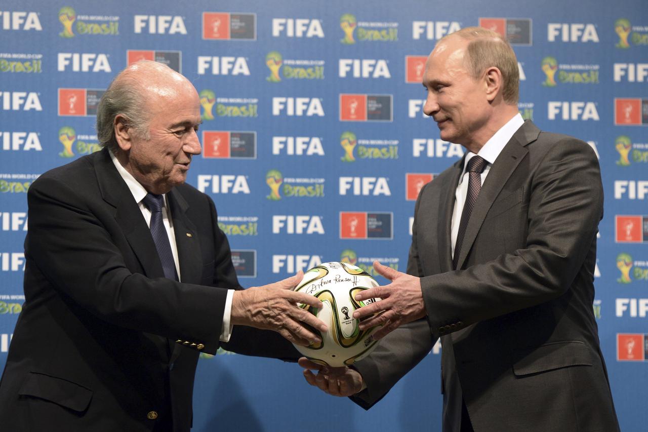 Russia's President Vladimir Putin (R) and FIFA President Sepp Blatter take part in the official hand over ceremony for the 2018 World Cup scheduled to take place in Russia, in Rio de Janeiro July 13, 2014.    REUTERS/Alexey Nikolsky/RIA Novosti/Kremlin   