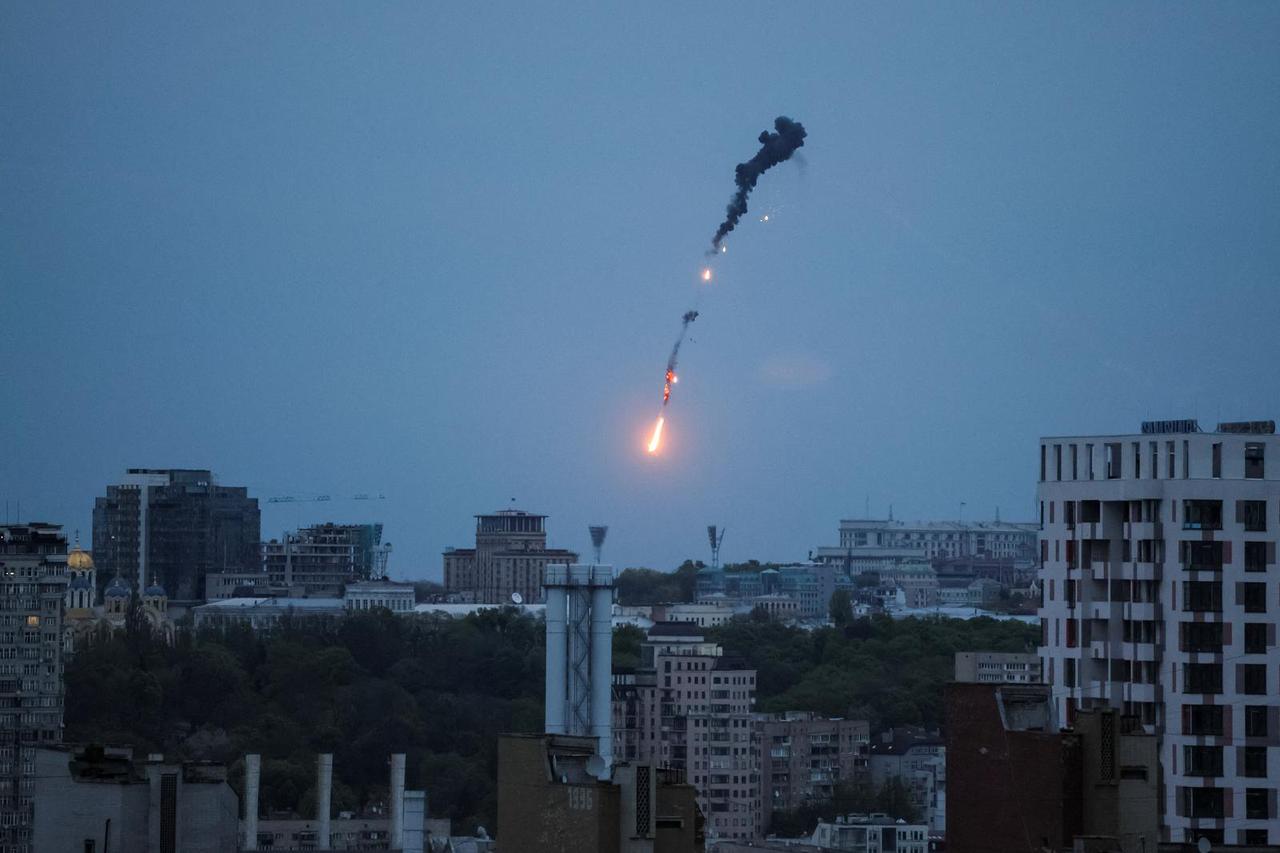An explosion of a drone is seen in the sky over the city during a Russian drone strike in Kyiv