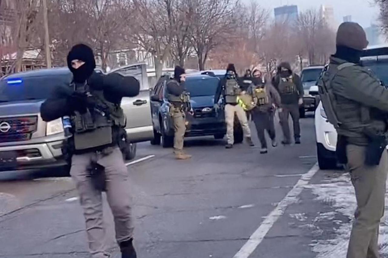 Members of U.S. Immigration and Customs Enforcement (ICE) respond at the scene where a woman was shot in Minneapolis