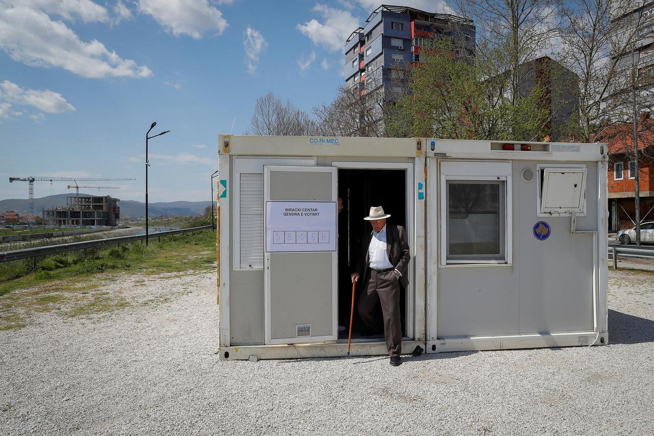 A man leaves a container used as an alternative voting center, in North Mitrovica