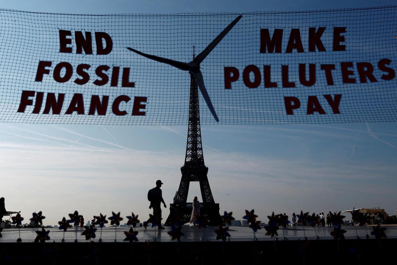 Activists turn Eiffel Tower into giant wind turbine to welcome world leaders in Paris