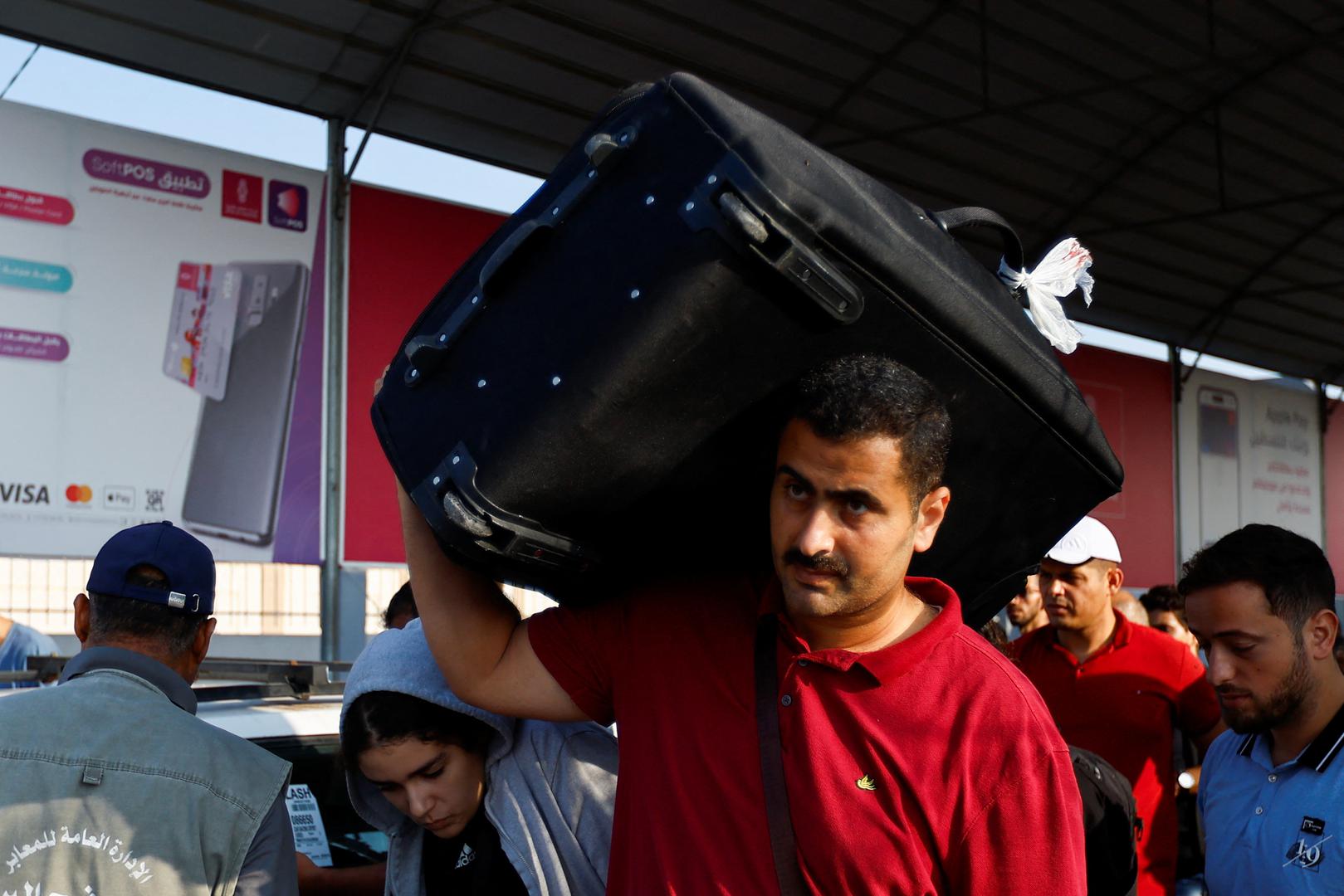 A man carries a piece of luggage as Palestinians with dual citizenship wait for permission to leave Gaza, amid the ongoing conflict between Israel and Palestinian Islamist group Hamas, at the Rafah border crossing with Egypt, in Rafah in the southern Gaza Strip, November 2, 2023. REUTERS/Ibraheem Abu Mustafa Photo: IBRAHEEM ABU MUSTAFA/REUTERS